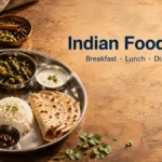 Indian thali with dal, sabzi, roti, rice and masala chai on a wooden table